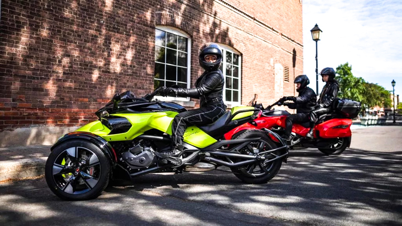 Trójkołowiec dla każdego z kat. B - Dwa trójkołowce z kobiętą na jednym i parą na drugim Dwa trójkołowce z kobiętą na jednym i parą na drugim